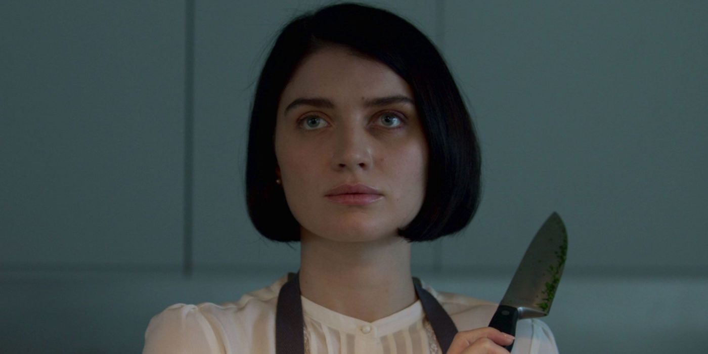 Eve Hewson holding a knife and looking intently ahead in 'Behind Her Eyes'