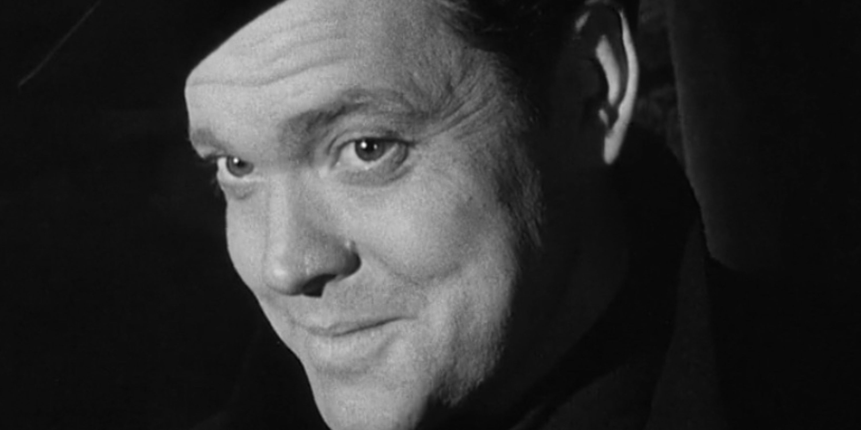 Orson Welles as Harry Lime smiling coyly in 'The Third Man' (1949)