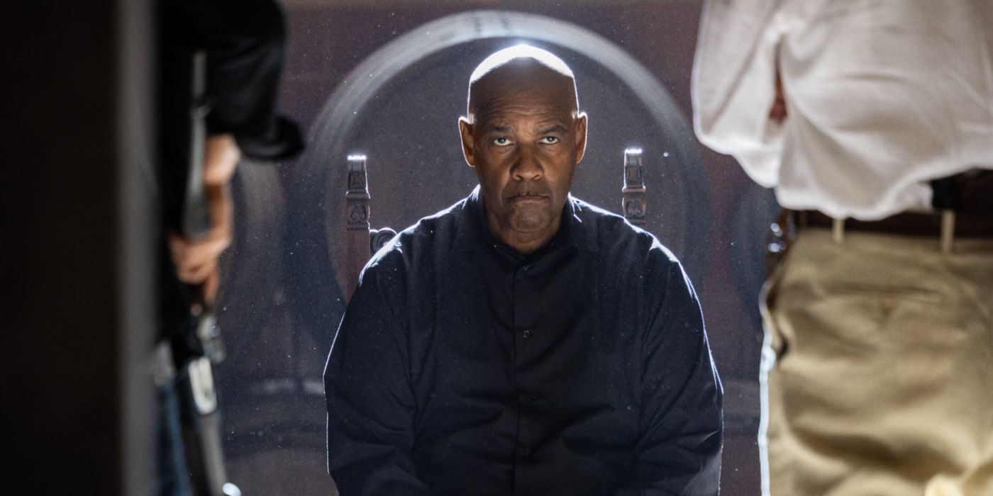 Denzel Washington as Robert McCall sitting on a chair while being confronted by mobsters in 'The Equalizer 3'