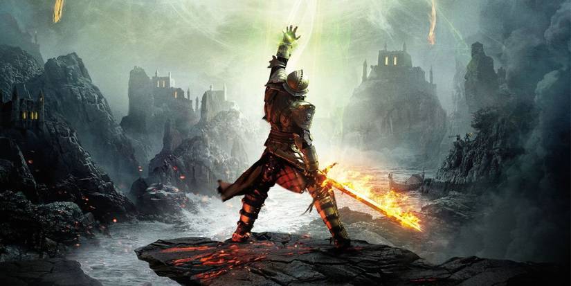 The Inquisitor with their back to the camera looking up and raising an arm in Dragon-Age-Inquisition