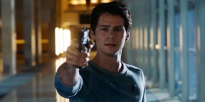 Dylan O'Brien pointing a gun at the screen and crying