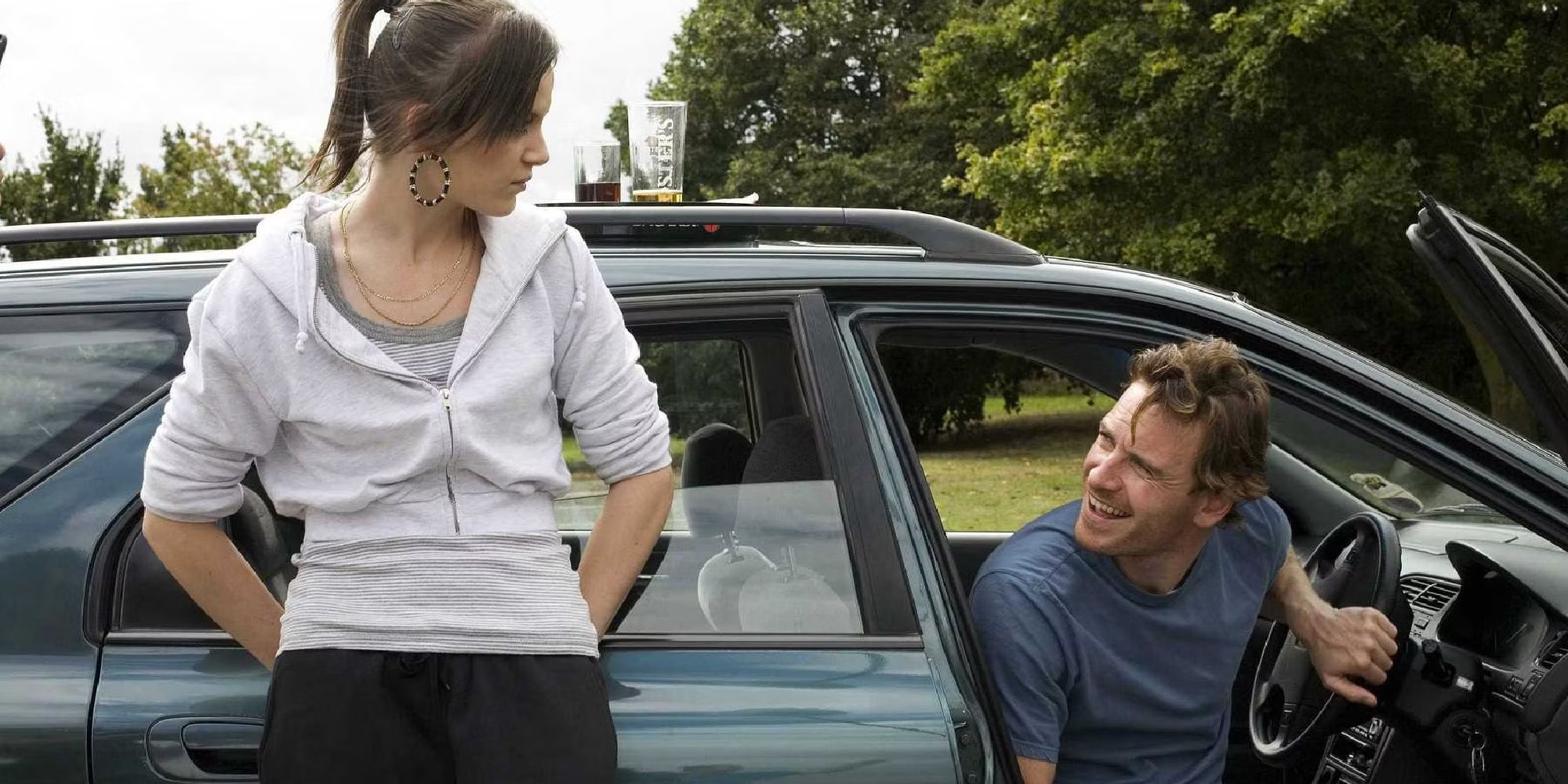 Katie Jarvis as Mia standing outside a car talking to Michael Fassbender as Connor in the film Fish Tank - 2009