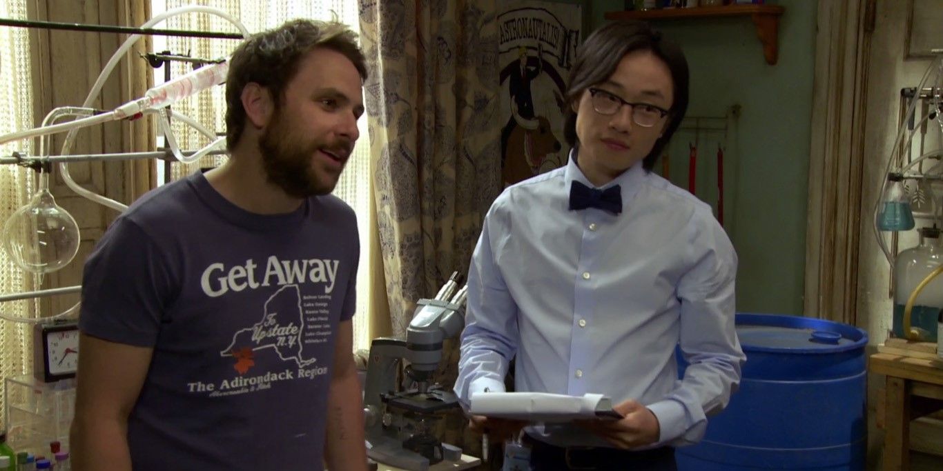 Still from 'It's Always Sunny in Philadelphia': Charlie stands in his apartment beside a scientist (Jimmy O. Yang)