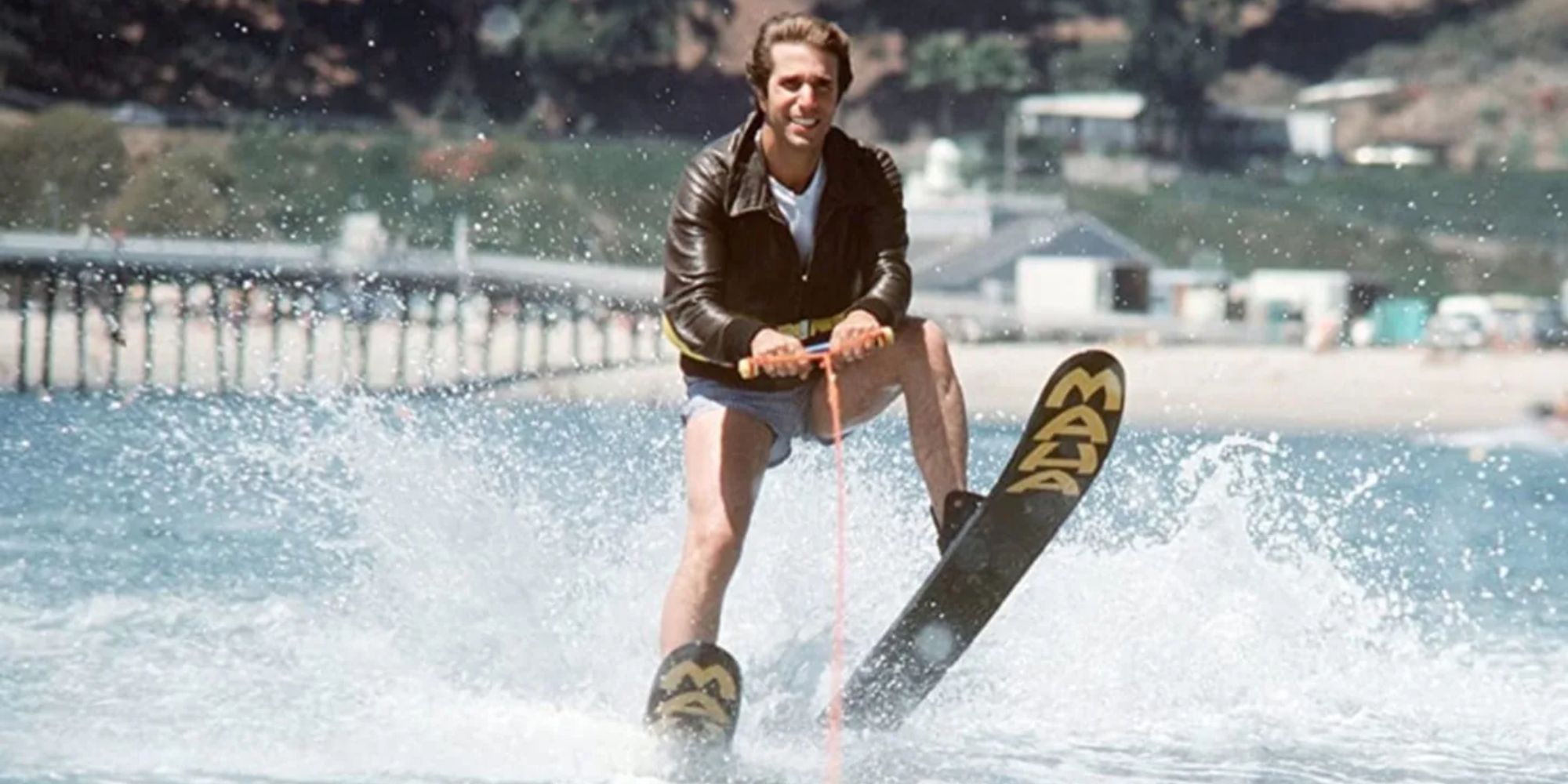 Henry Winkler as Fonzie on water skis and prepares to jump the shark