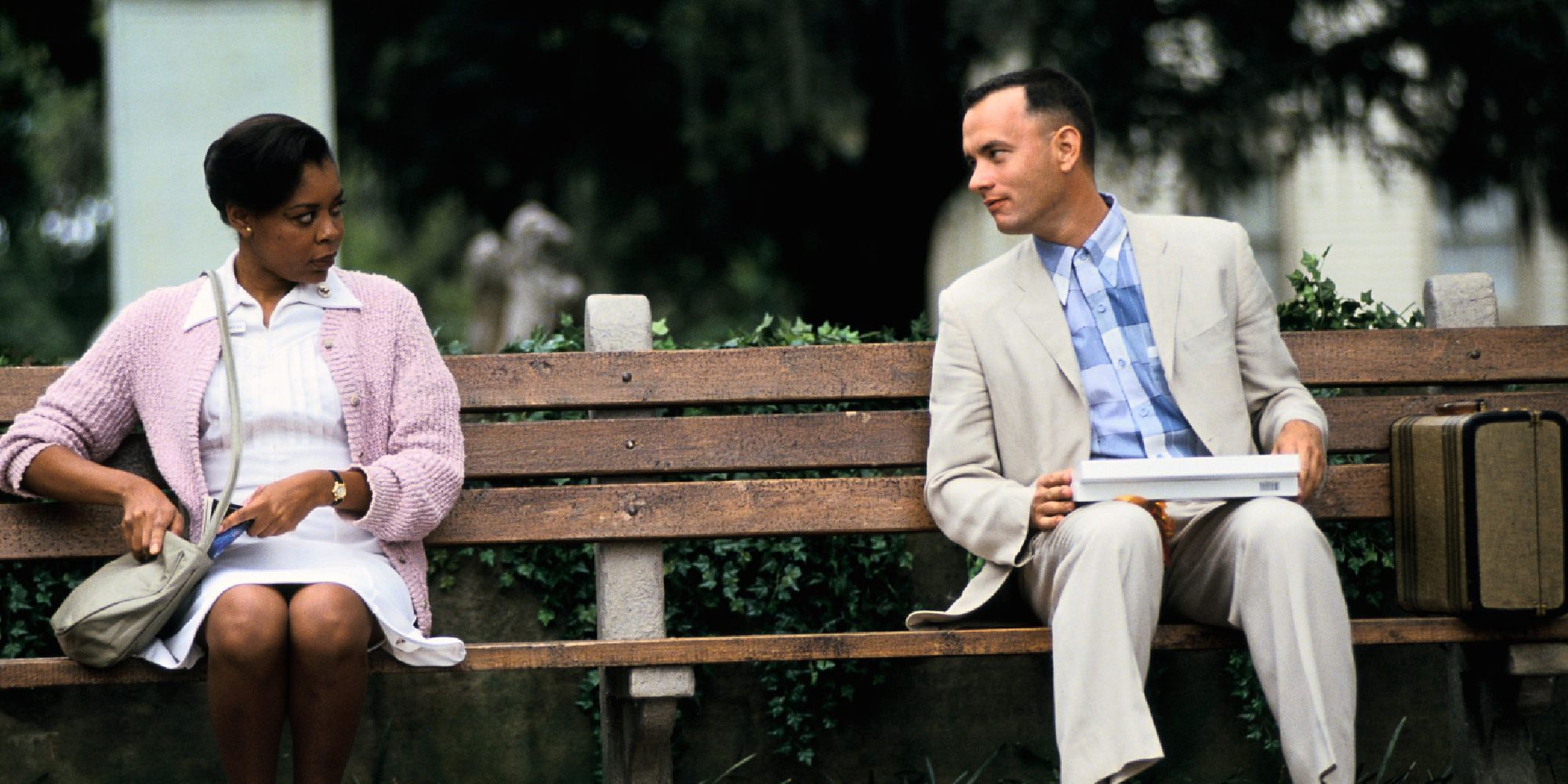 Forrest Gump talking to a nurse while sitting on a park bench in Forrest Gump