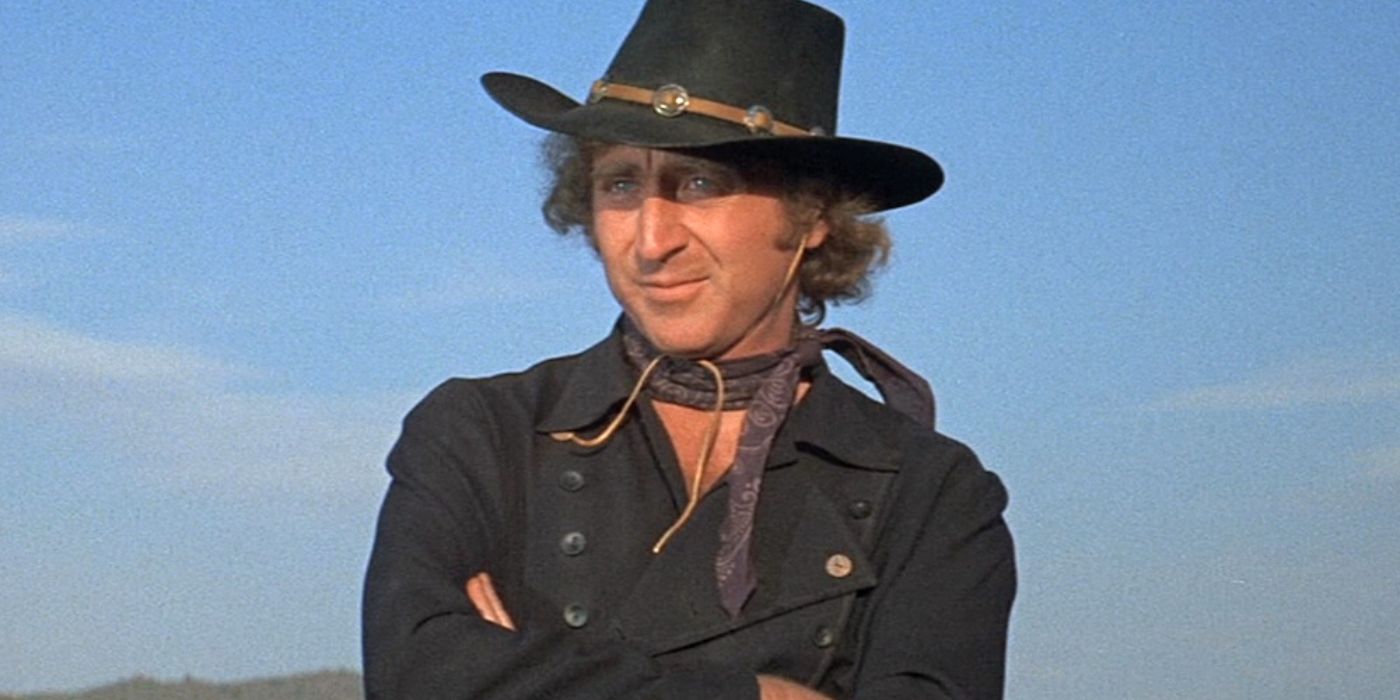 Gene Wilder sitting with his arms crossed in Blazing Saddles