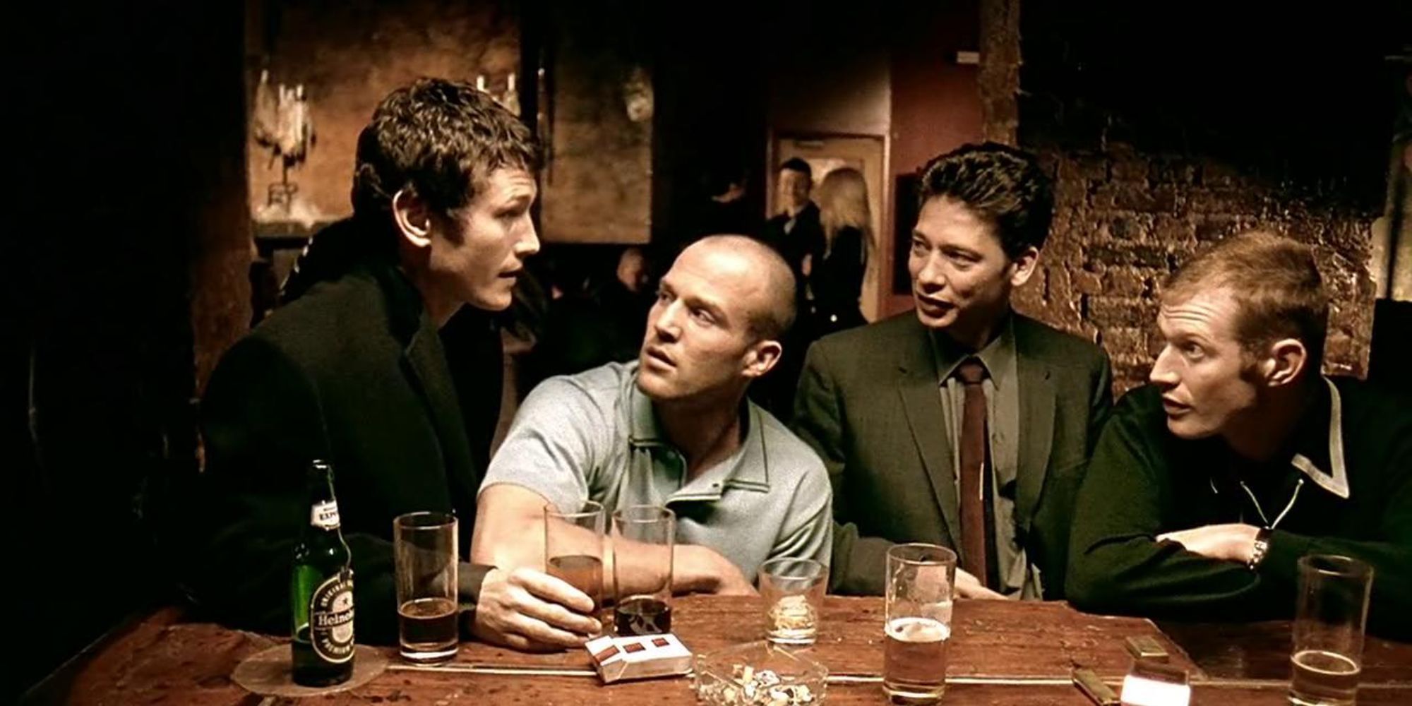 Jason Flemyng, Jason Statham, Dexter Fletcher, Nick Moran discussing in a bar in Lock, Stock and Two Smoking Barrels