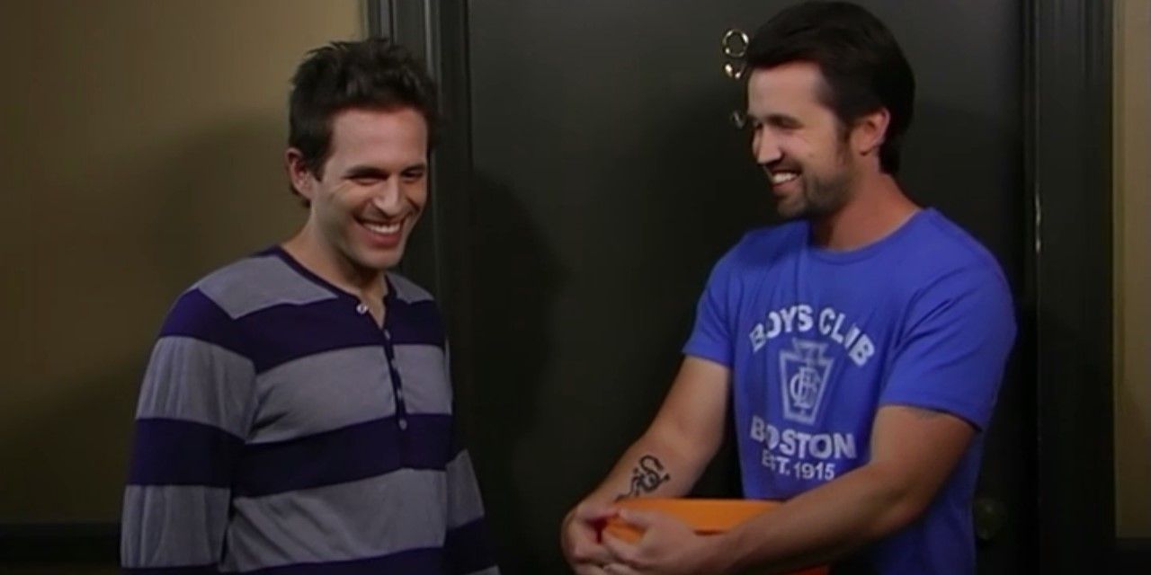 Still from 'It's Always Sunny in Philadelphia': Mac and Dennis stand side by side, smiling.