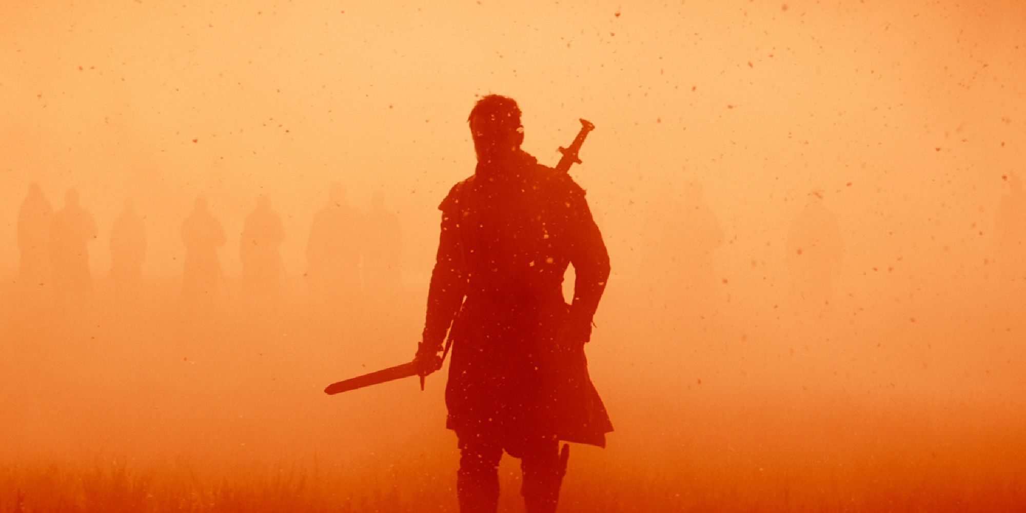 Macbeth's silhouette walking through a dusty battle field in the film Macbeth.