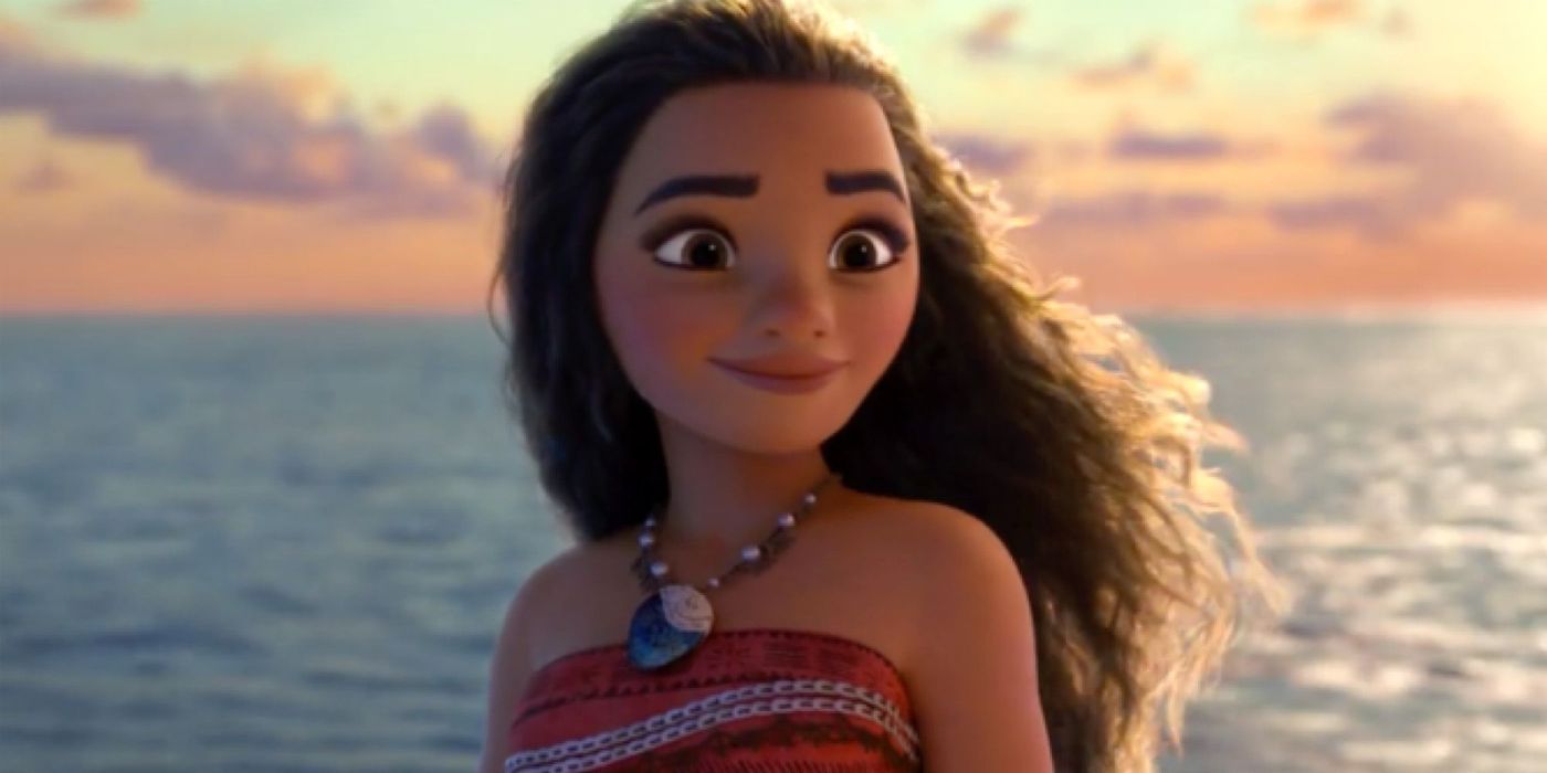 Moana smiling in front of the ocean in Disney's Moana