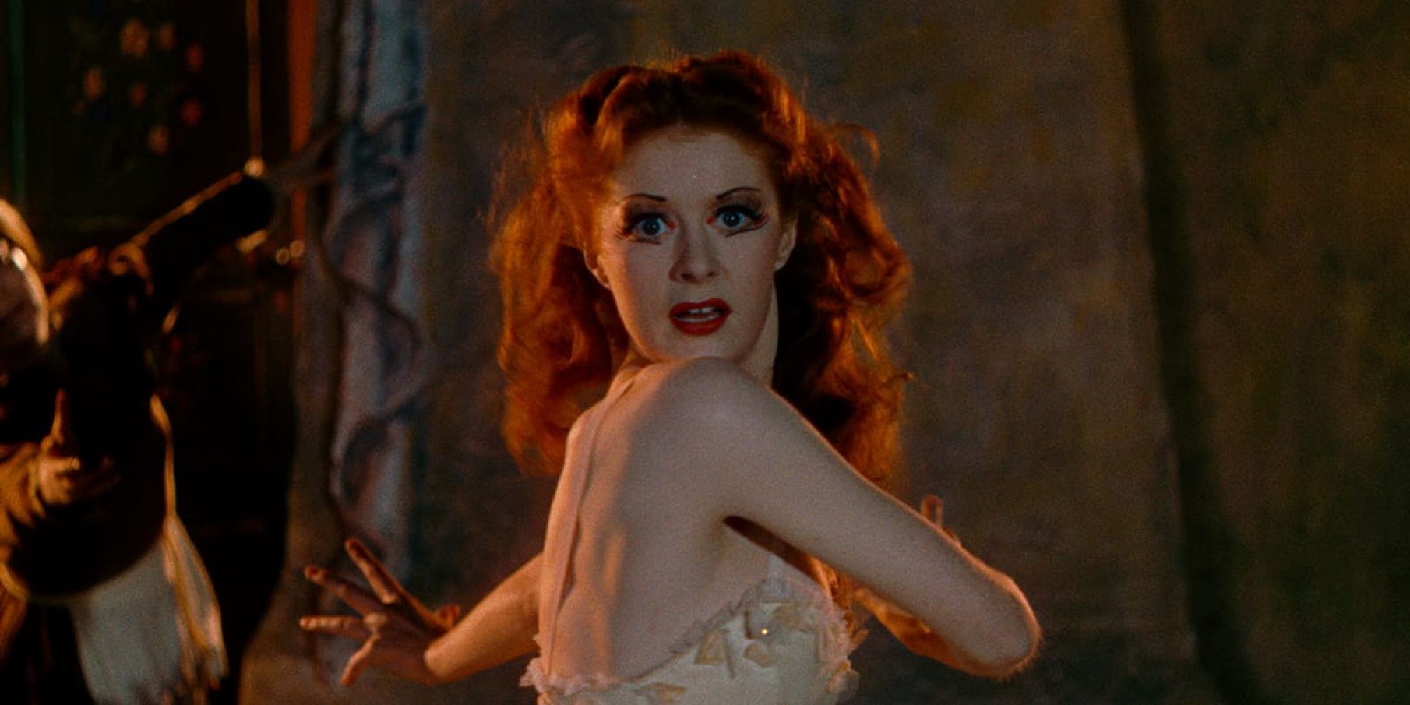 Moira Shearer as Victoria looking at the camera while dancing in The Red Shoes