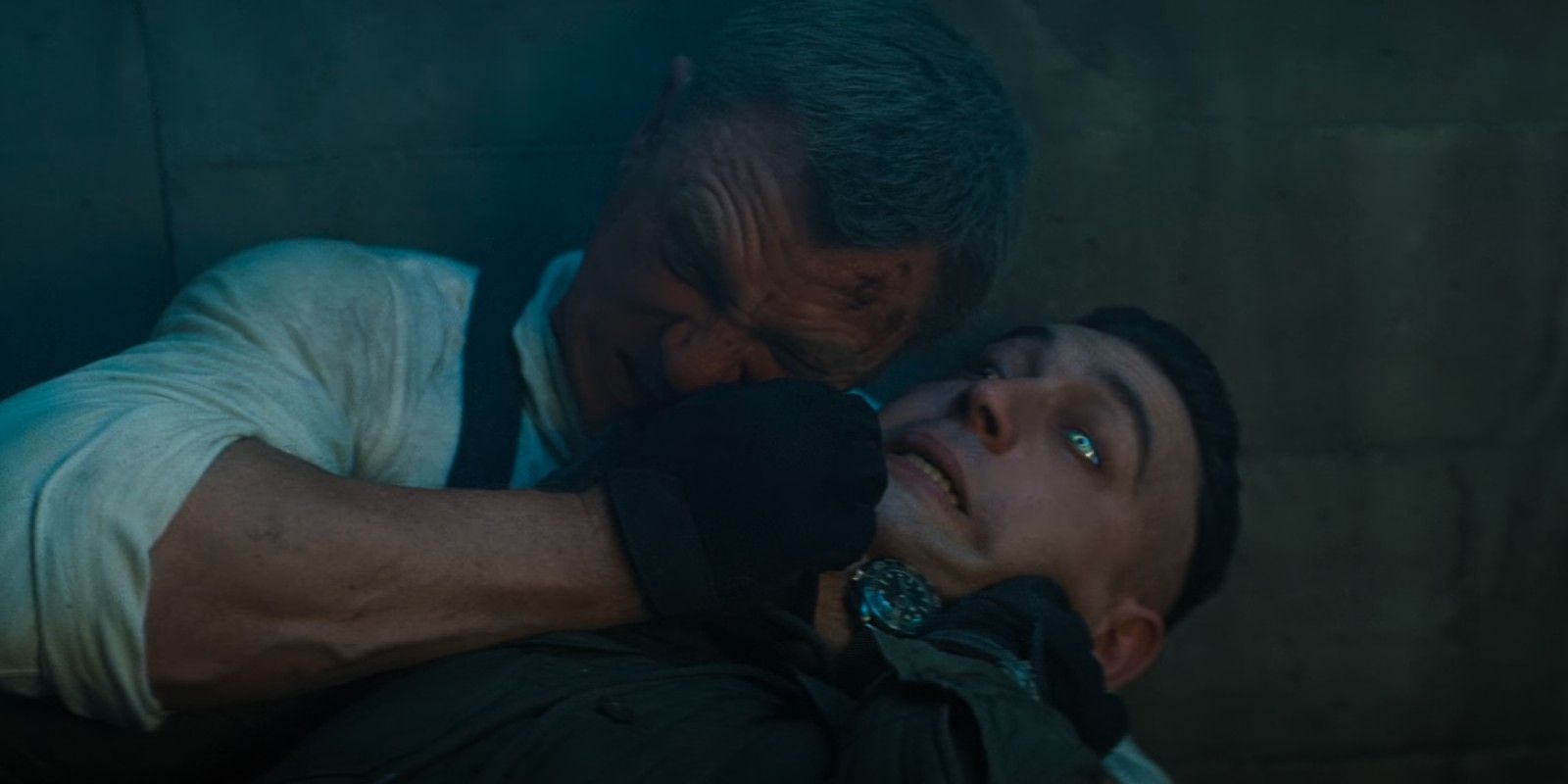 James Bond wrestles with Primo, using his EMP device in his watch to overcharge the henchman's bionic eye.