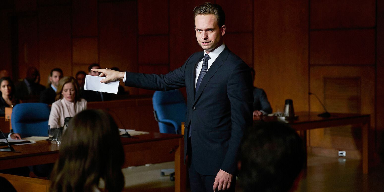 Patrick J. Adams in 'Suits', arguing in court with a paper envelope in hand