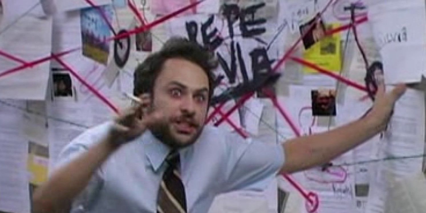 Still from 'It's Always Sunny in Philadelphia': Charlie stands in front of a conspiracy board looking manic and smoking.