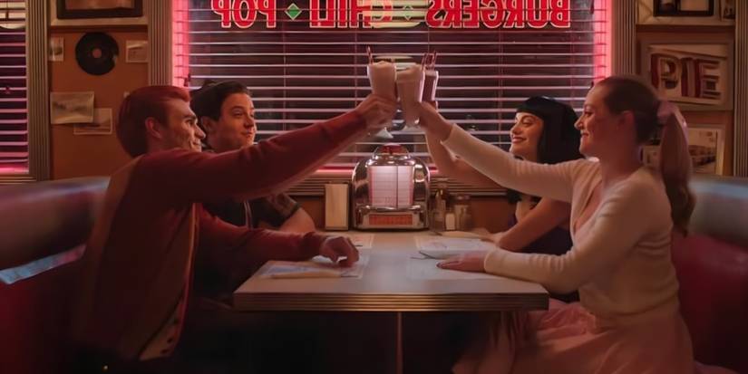 Archie, Betty, Veronica and Jughead cheers milkshakes, sitting in a diner in the Riverdale series finale.