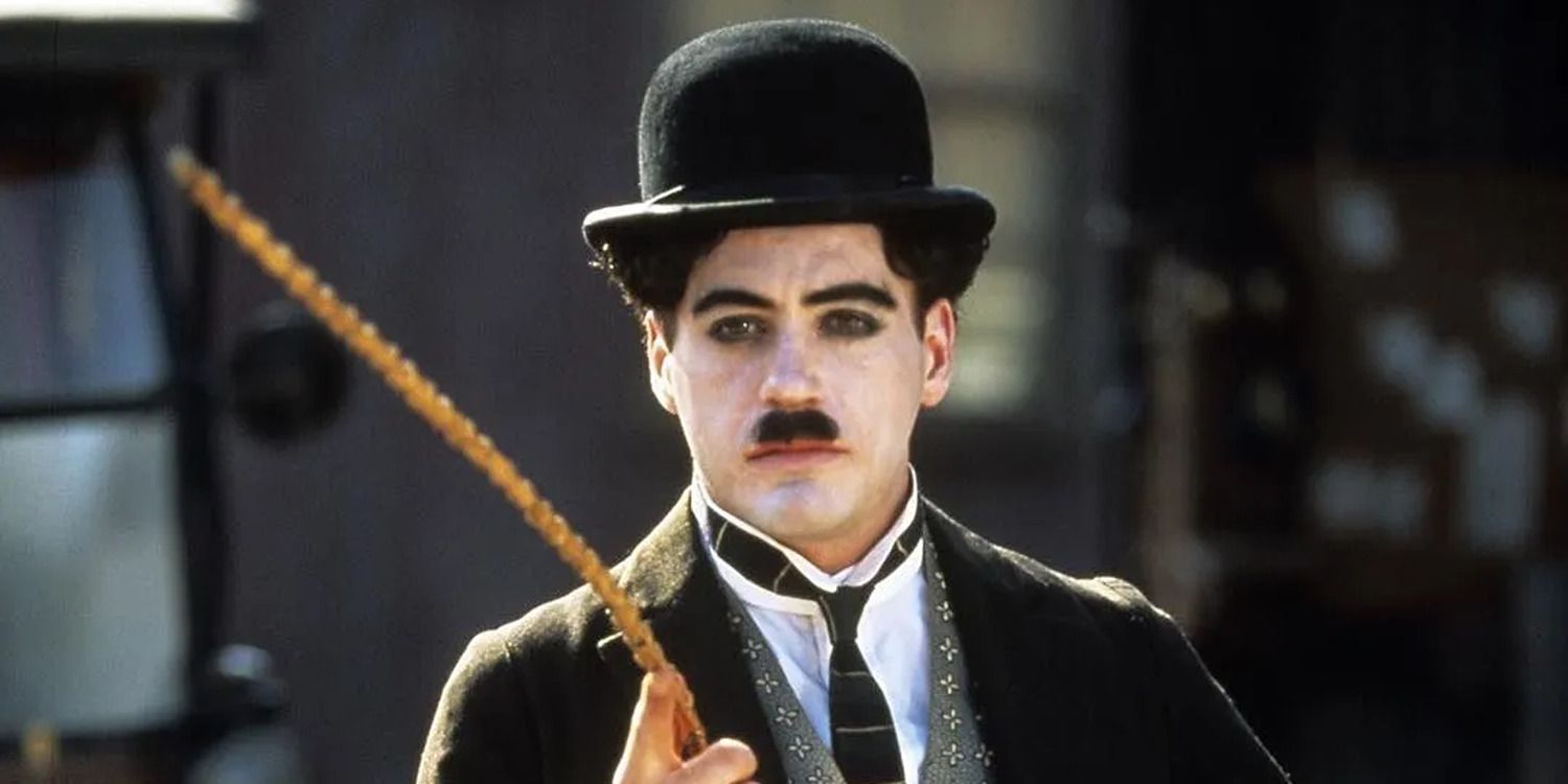Robert Downey Jr as the Little Tramp holding his cane