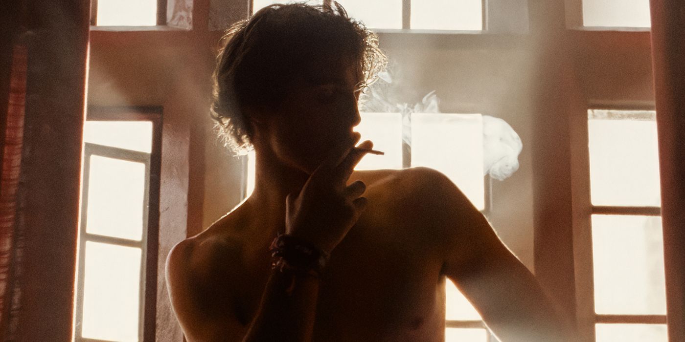 Jacob Elrodi, shirtless, smoking a cigarette on a poster for Saltburn