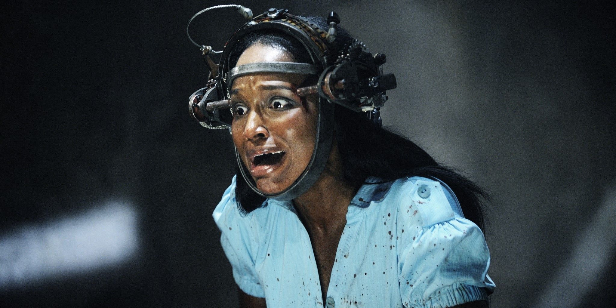 Still from Saw VI: Simone (Tanedra Howard) wears a metal head contraption and screams.