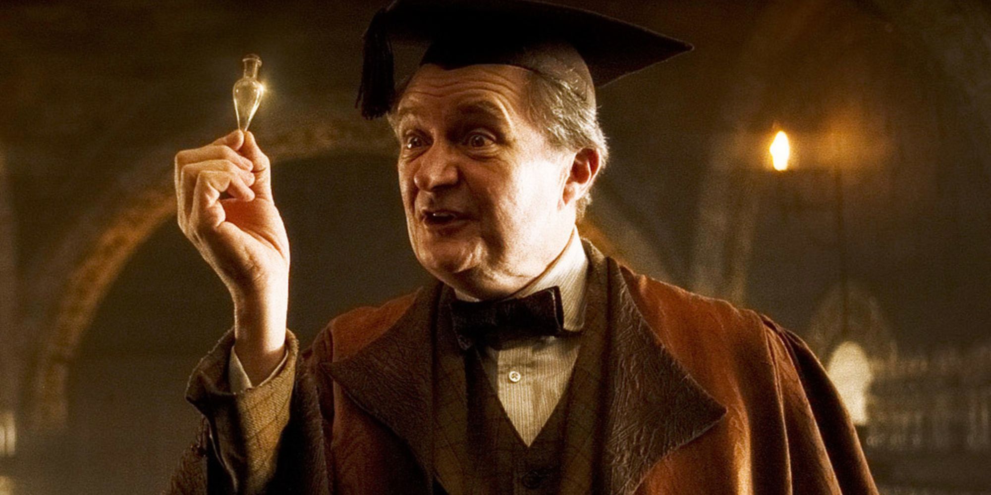 Slughorn holds a vial of Liquid Luck