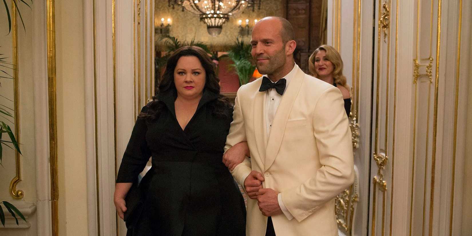 Susan and Rick Ford walking into a fancy party in Spy