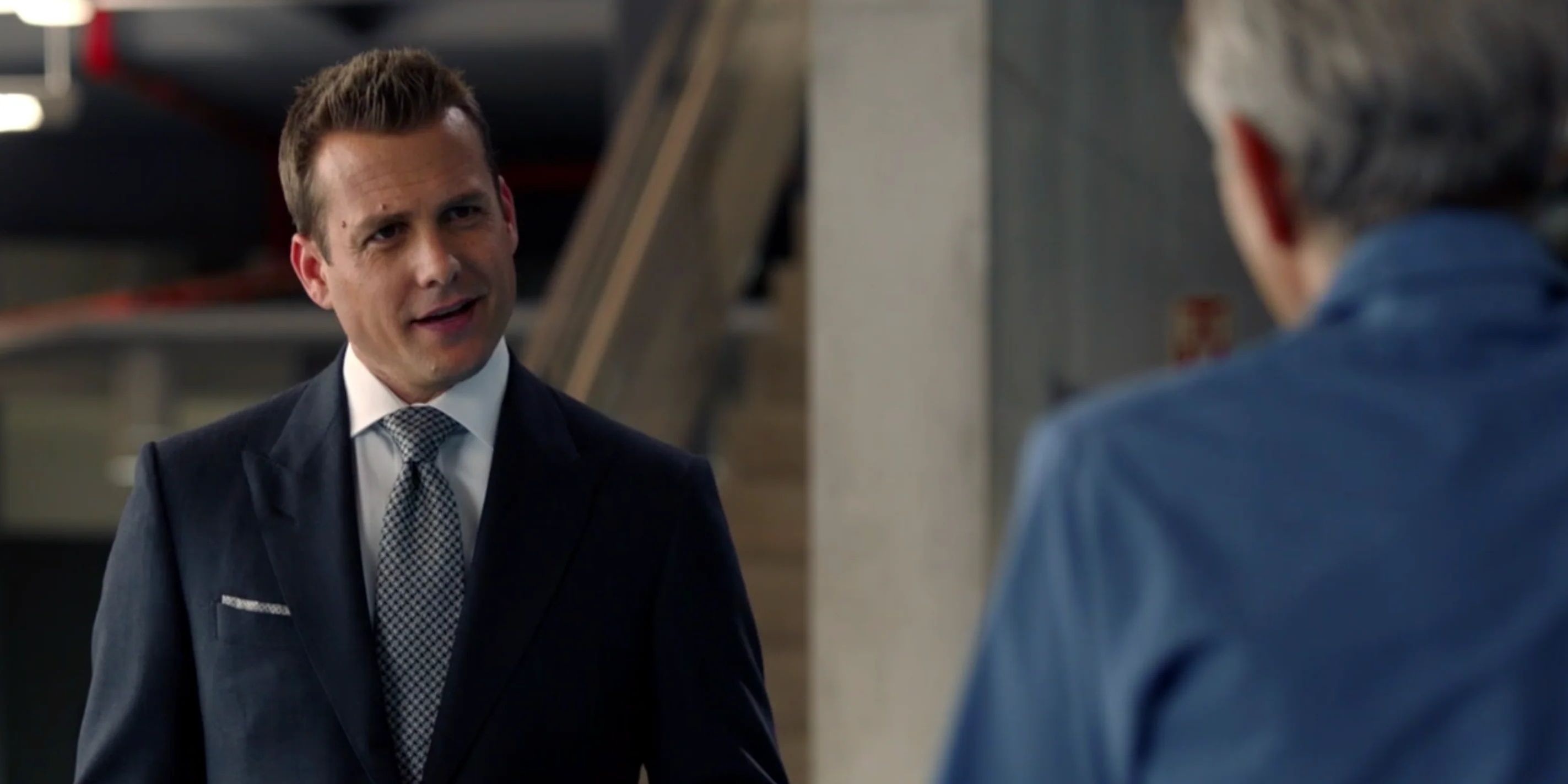Harvey speaking angrily to someone in a scene from Suits.