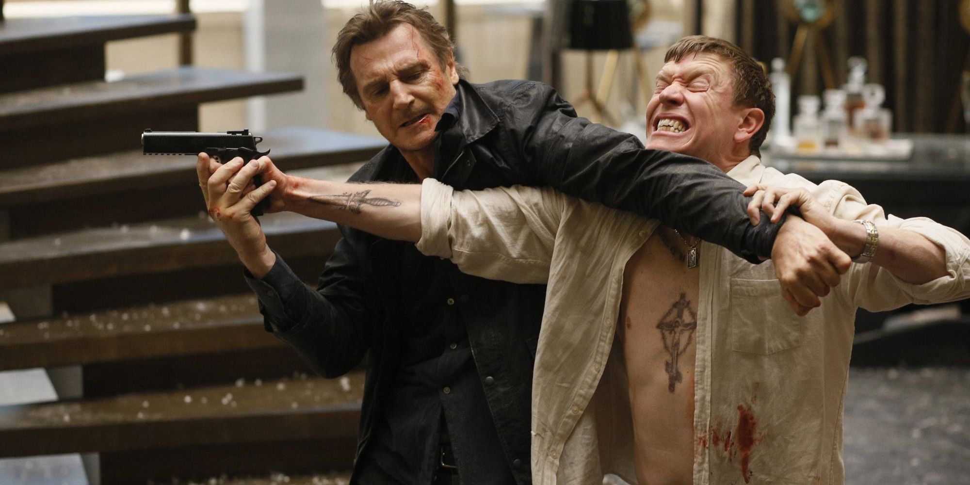 Liam Neeson fighting a gangster in Taken 3