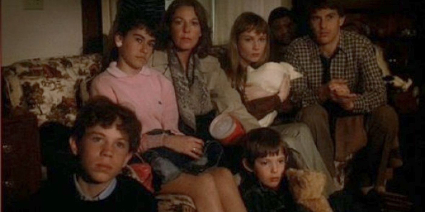 A group of people on a couch watching TV in the 1983 movie, 'Testament.'