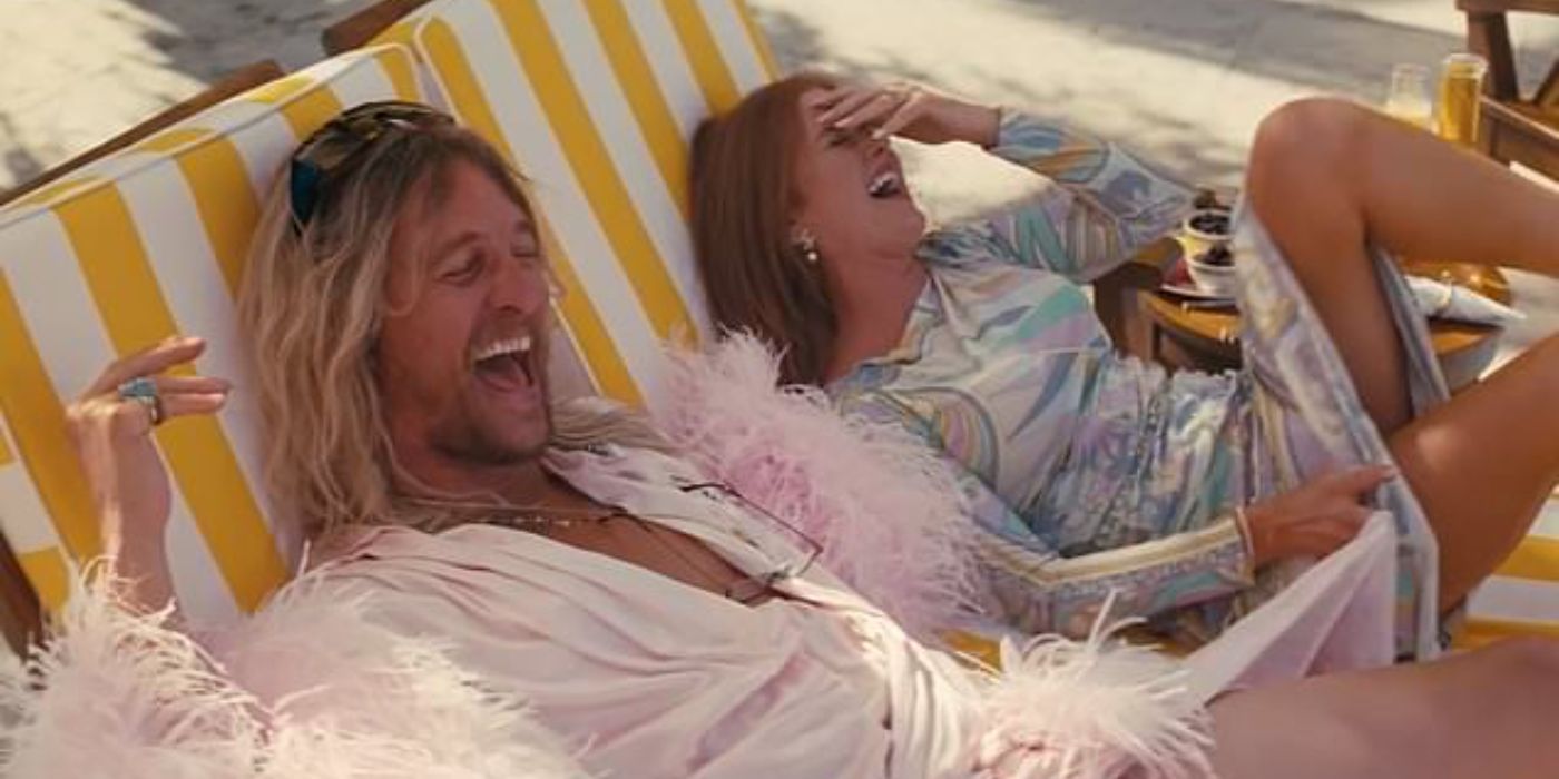 Matthew McCounaghey and Isla Fisher as Moondog and Minnie laughing in The Beach Bum.