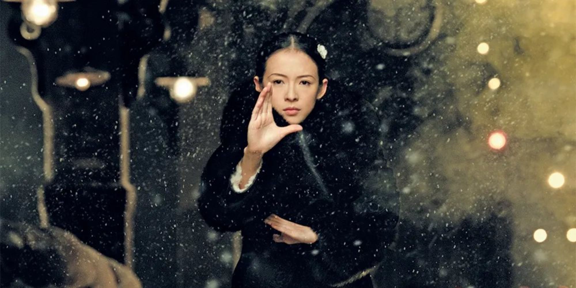 Ziyi Zhang as Gong Er, standing with her hands raised in front of her in The Grandmaster