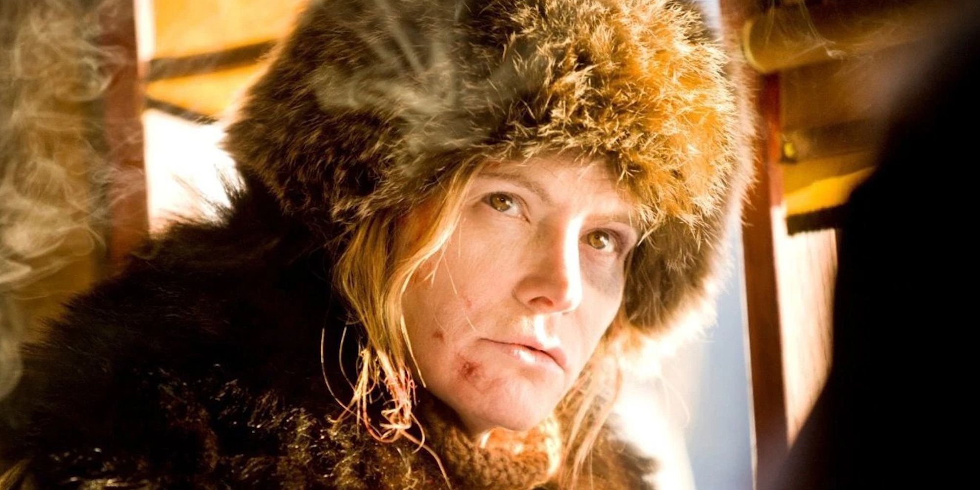 A close up of Jennifer Jason Leigh as Daisy Domergue in The Hateful Eight