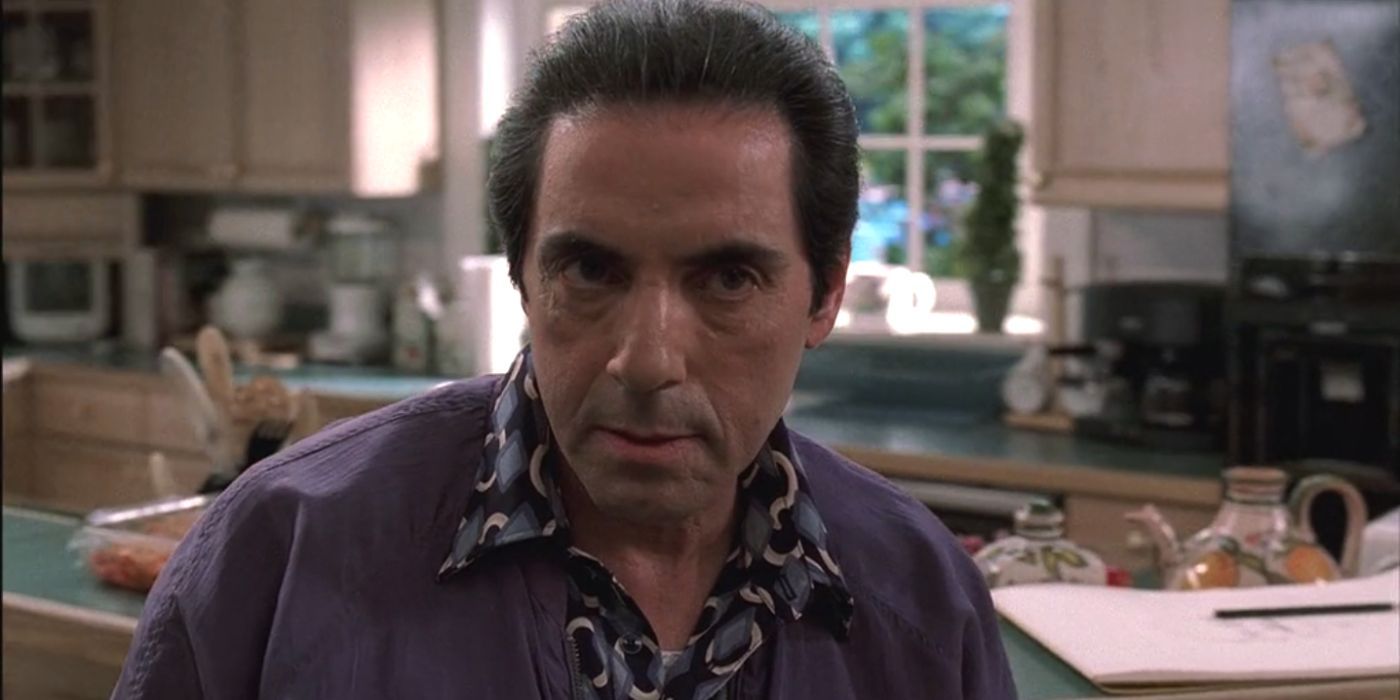 David Proval sitting in a kitchen in The Sopranos 