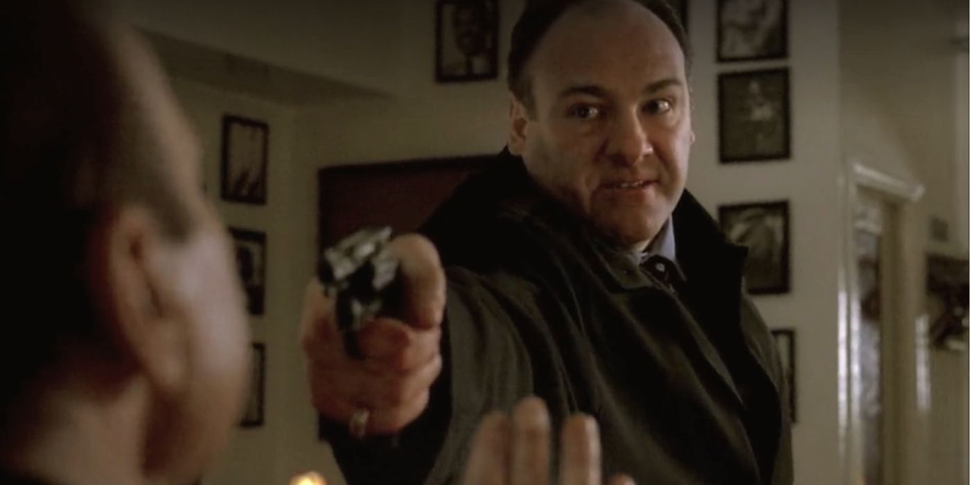 James Gandolfini pointing a gun at someone in The Sopranos