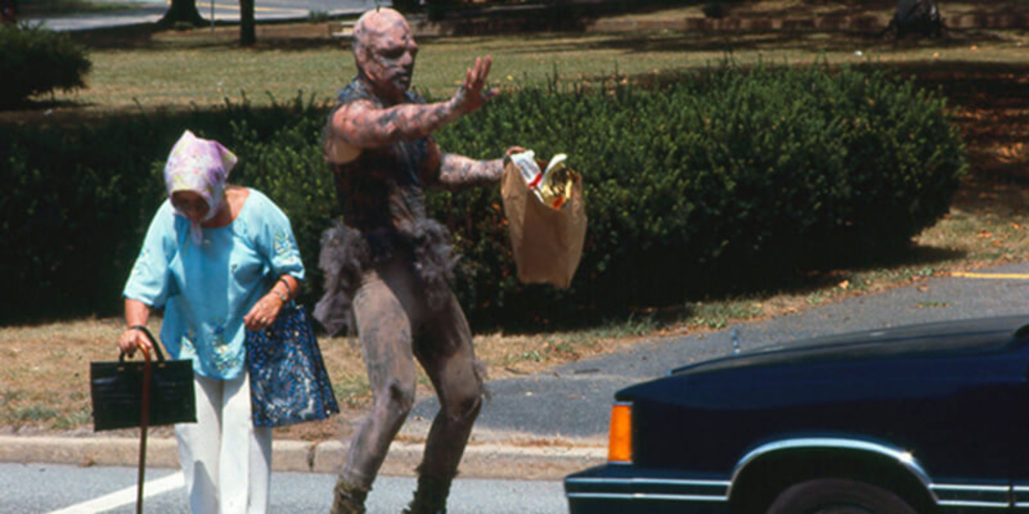 The Toxic Avenger stopping a car for an elderly woman to cross the street