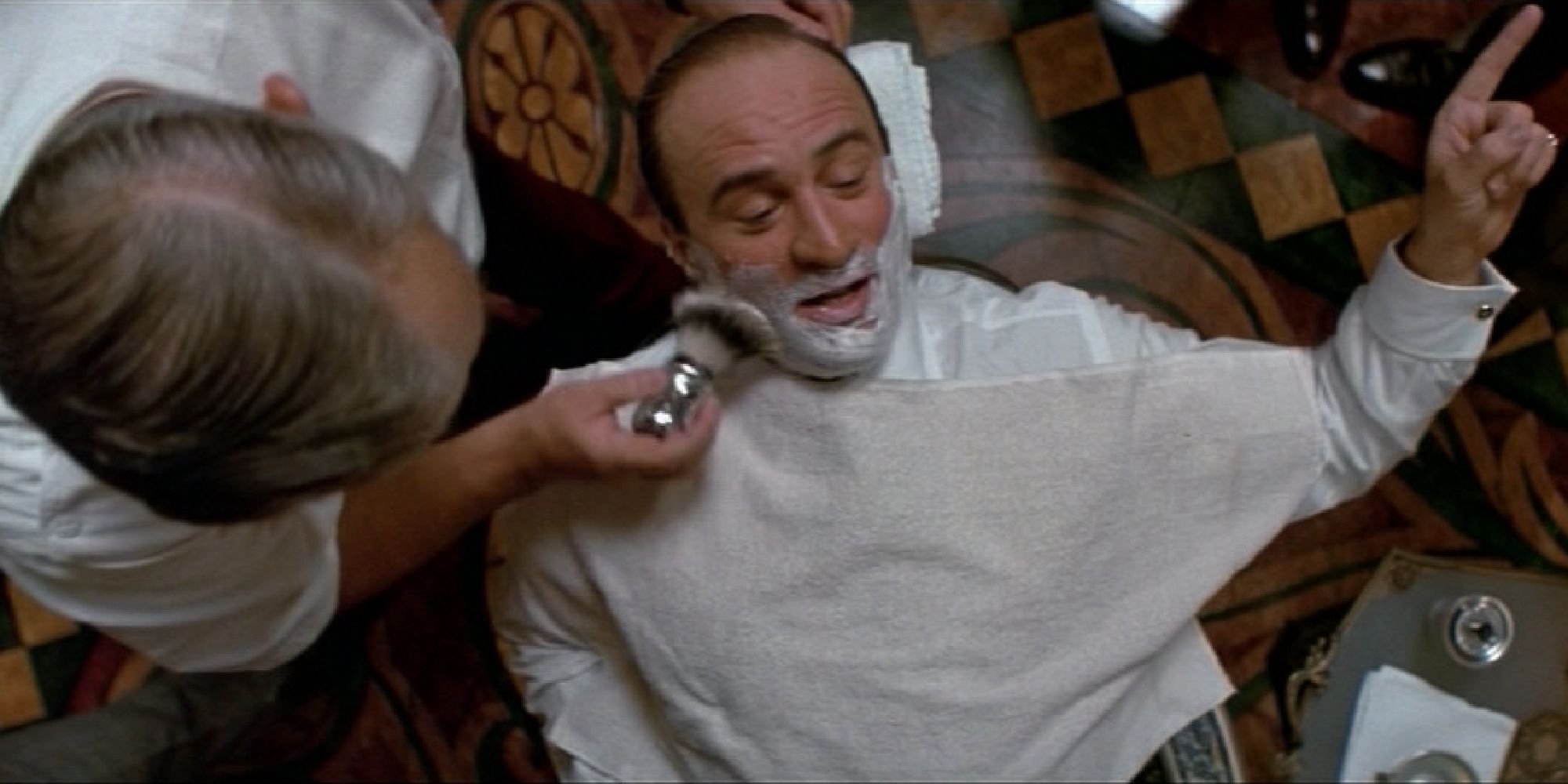 Al Capone talking to someone while being shaved in The Untouchables
