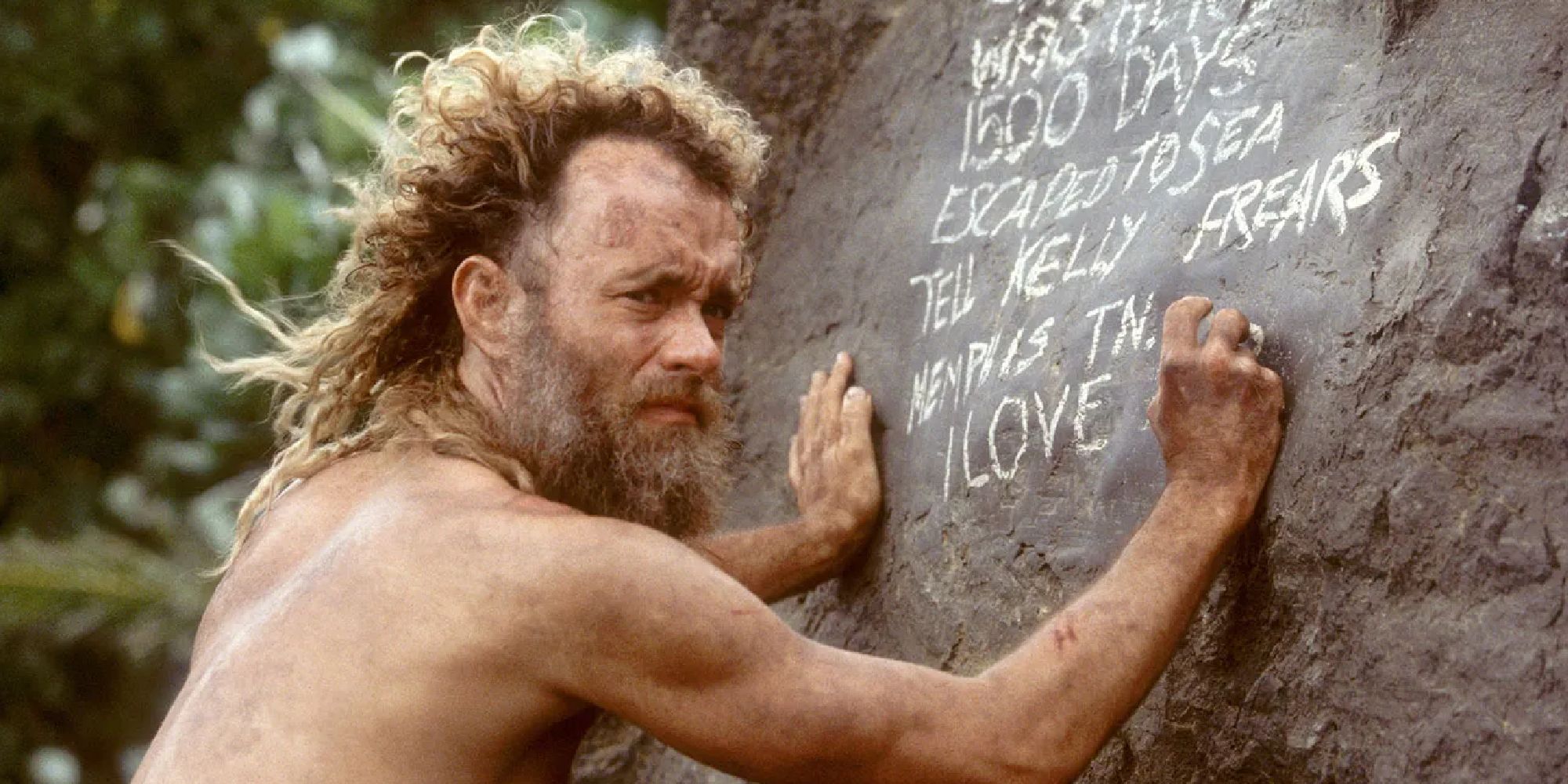 Tom Hanks writing on a rock in Cast Away