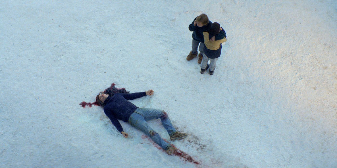 Two people look at a deceased body in the snow in 'Anatomy of a Fall.'