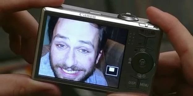 Still from 'It's Always Sunny in Philadelphia': a digital camera display shows a picture of Charlie looking washed out and smiling awkwardly.