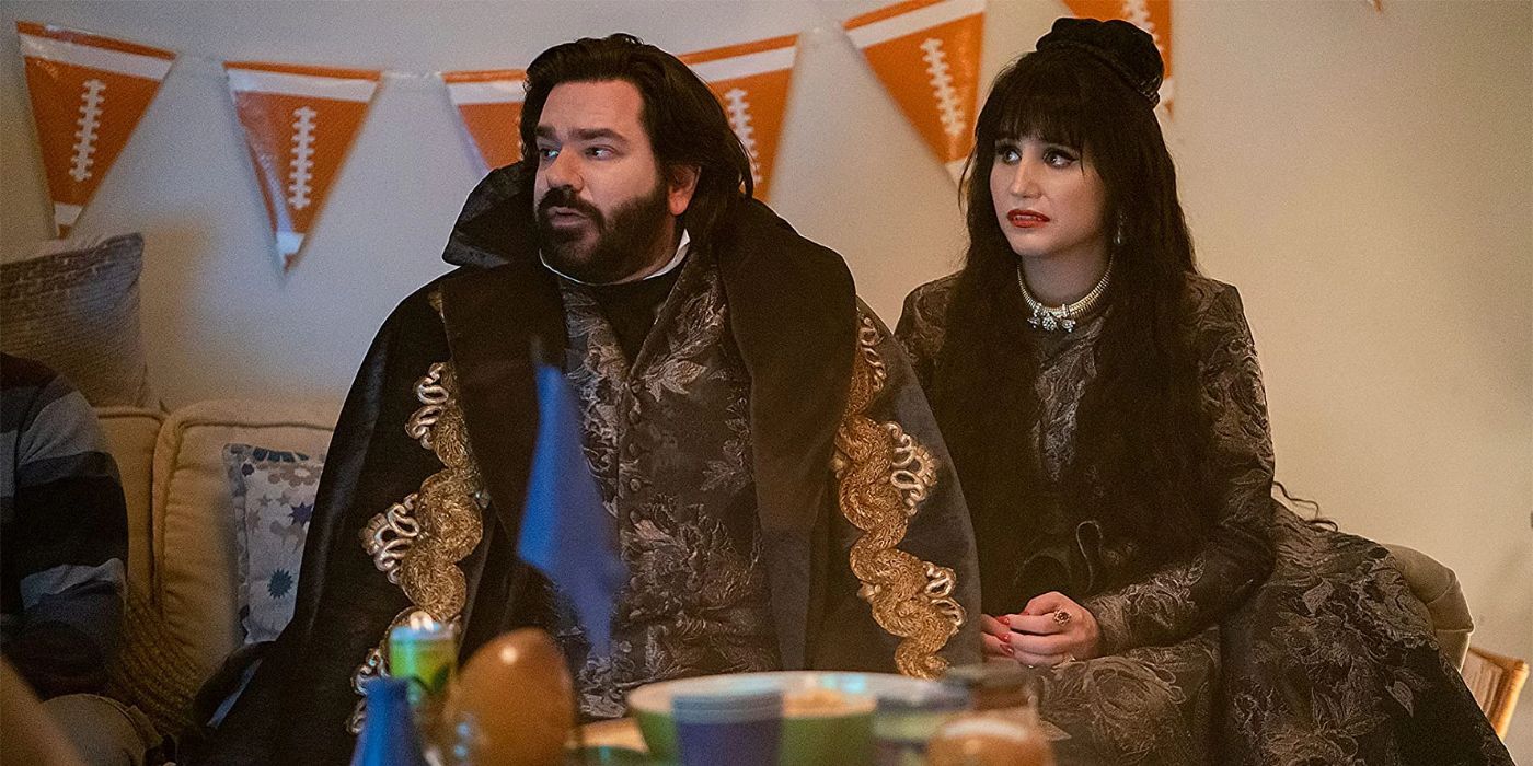 Laszlo, played by Matt Berry, sitting on a couch with Nadja, played by Natasia Demetriou, in What We Do in the Shadows.