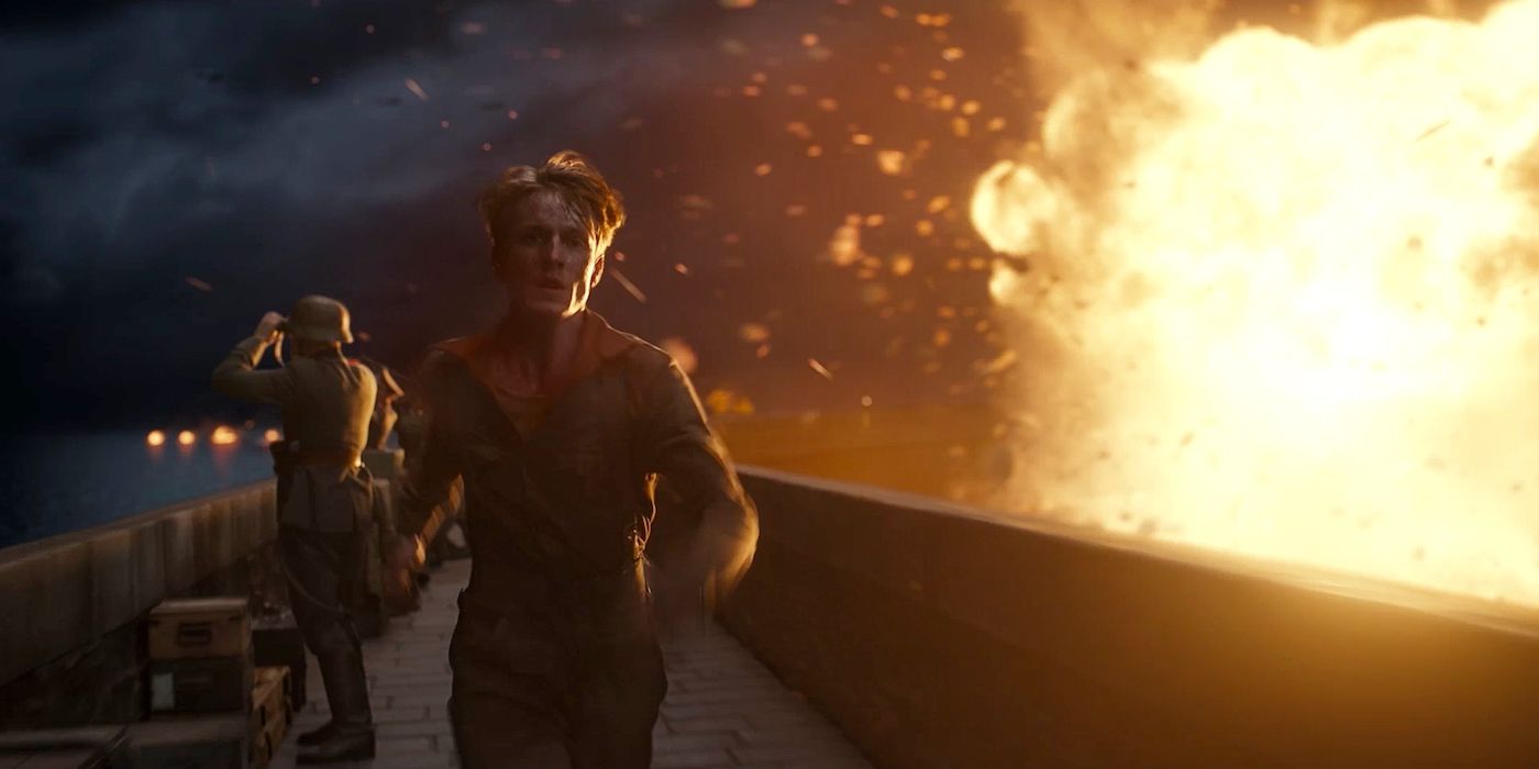 Louis Hofmann as Werner runs from an explosion in All the Light We Cannot See. 