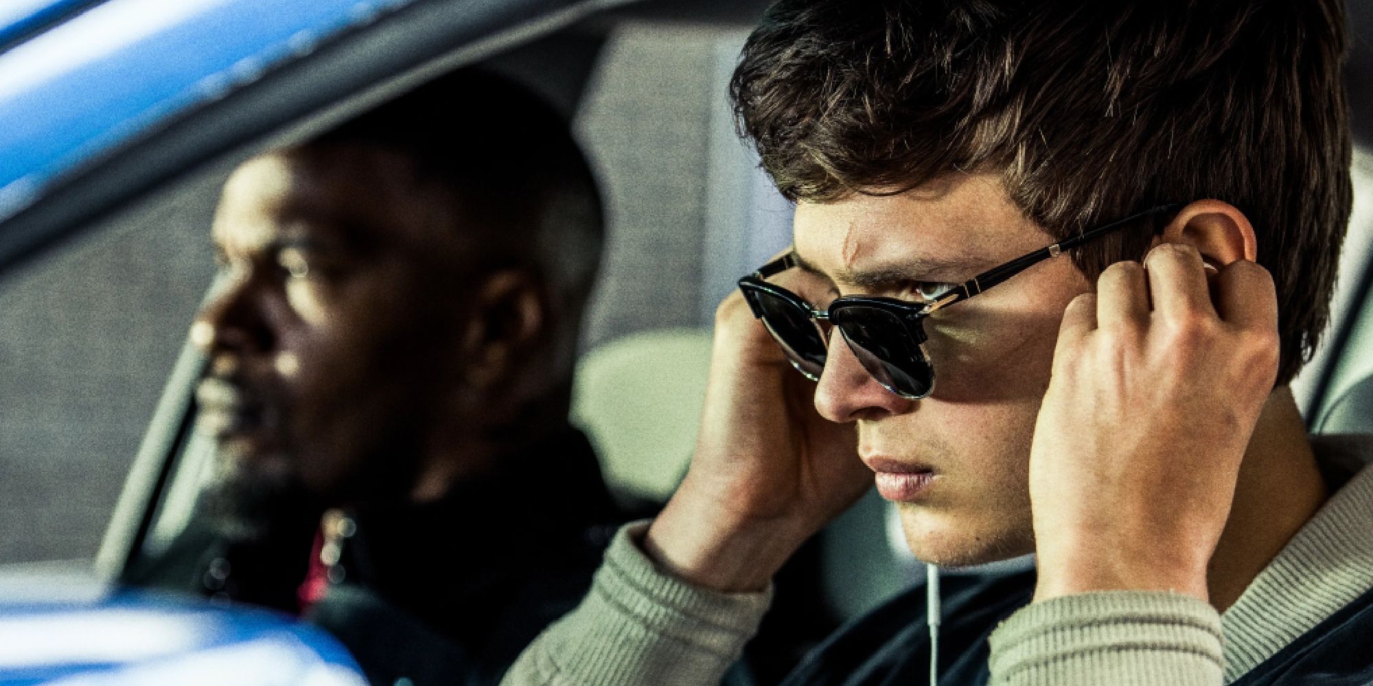 Ansel Elgort behind the wheel and Jamie Foxx in the passenger seat in Baby Driver