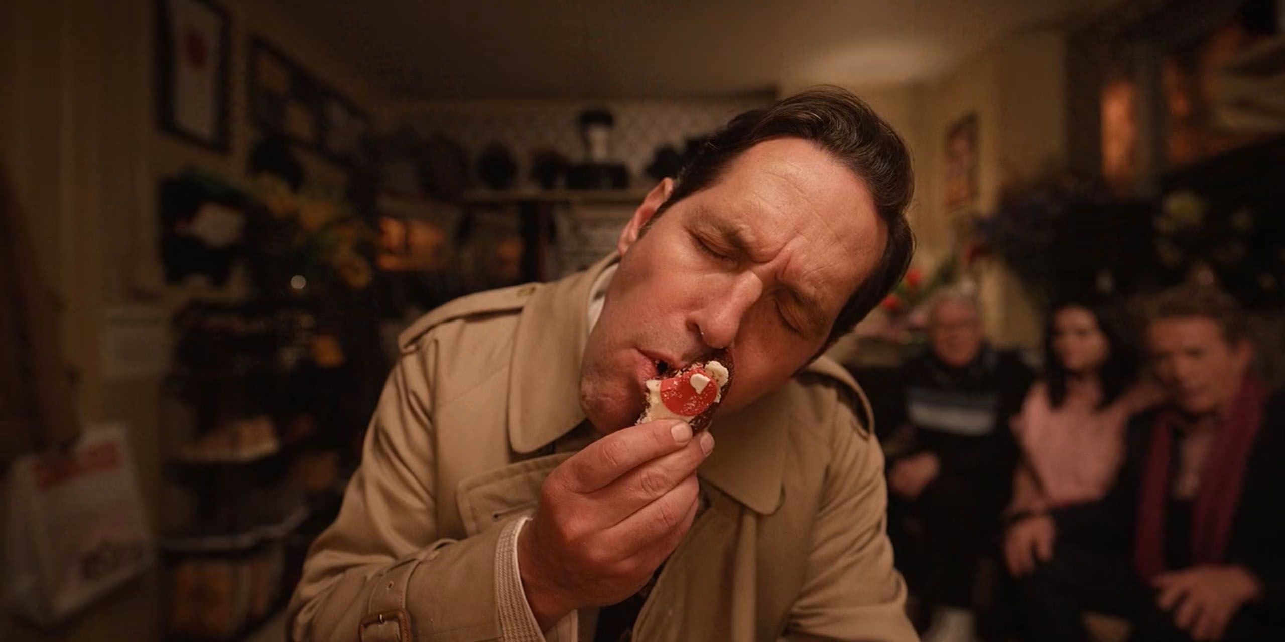 Paul Rudd as Ben Glenroy eating a cookie in front of his dressing room mirror in Hulu's Only Murders In The Building