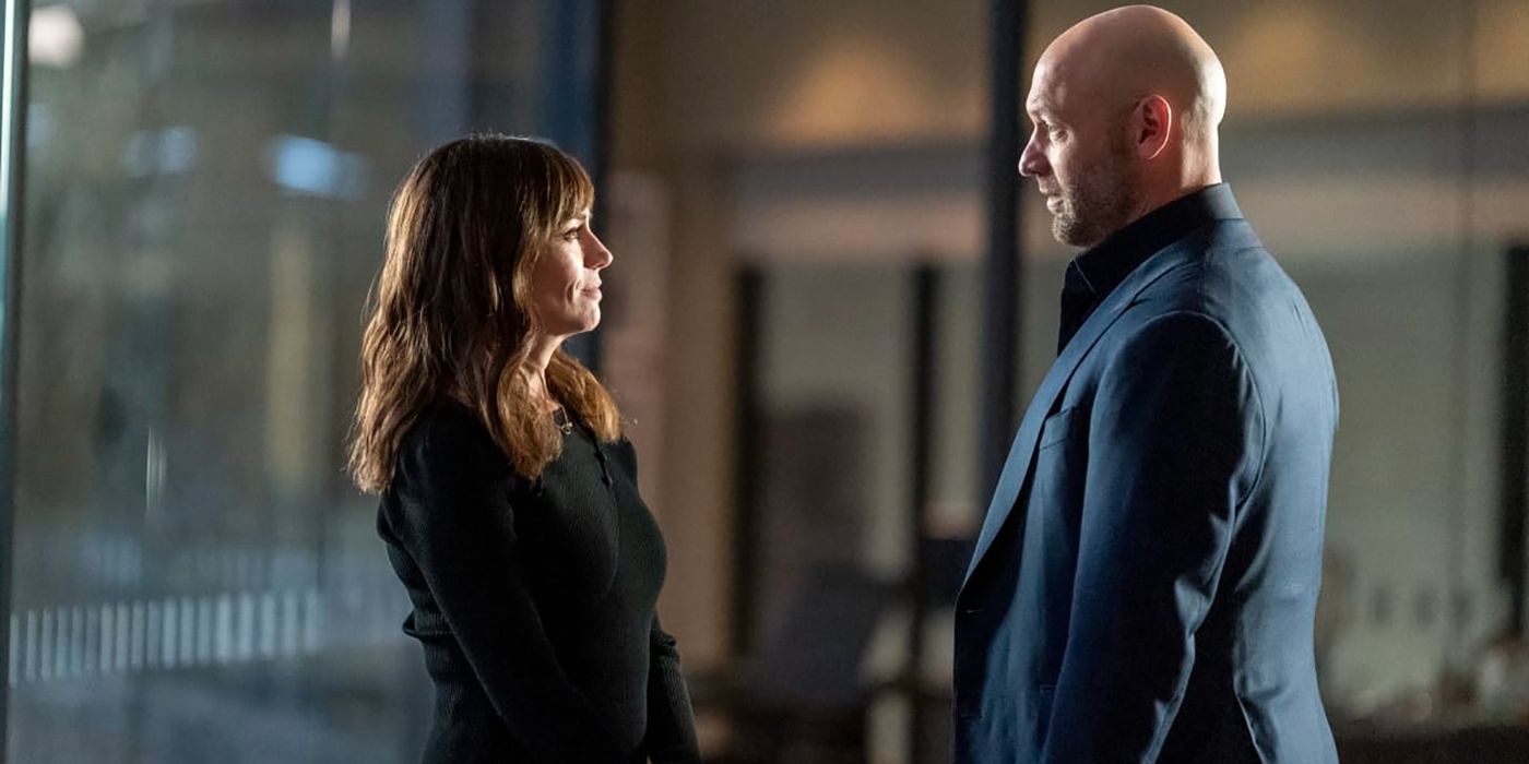 Wendy and Mike standing face to face in a scene from Billions.