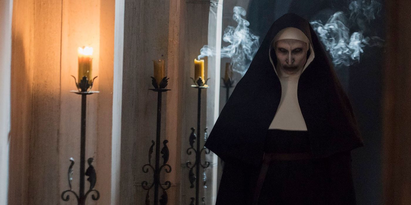 Bonnie Aarons as the Demon nun Valak standing menacingly in The Nun (2018)