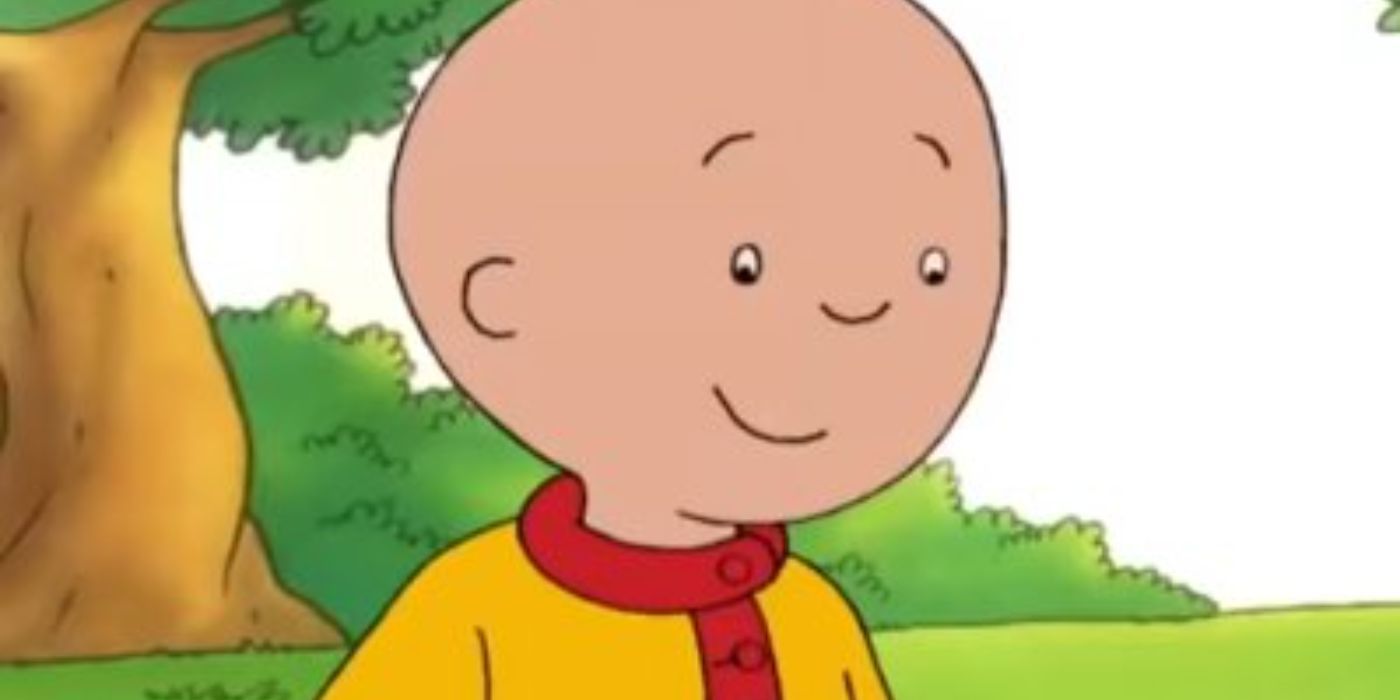 Caillou, a bald child cartoon, stands outside under a tree and smiles in Caillou.