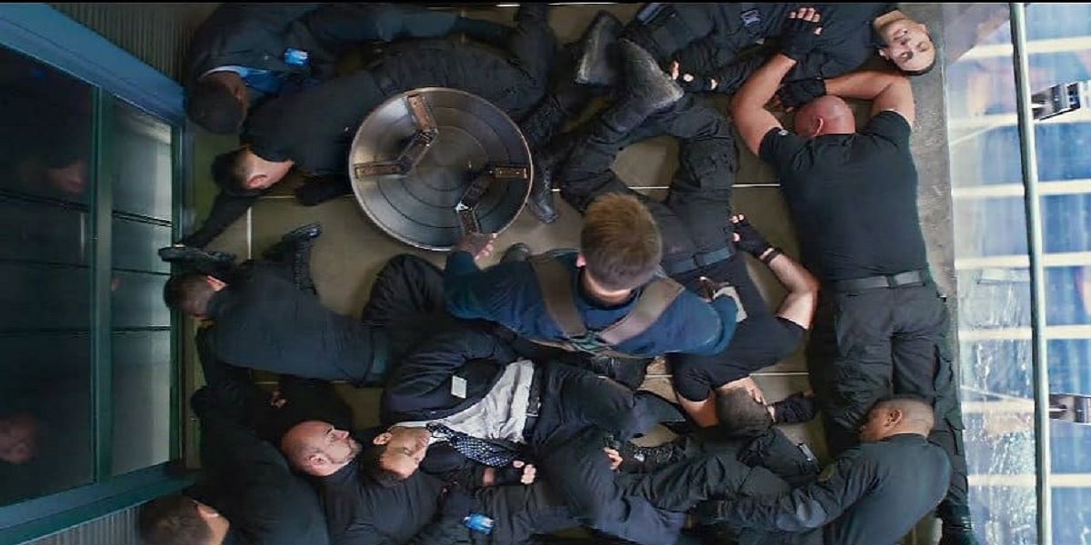 Captain America (Chris Evans) surveys his fallen opponents from the elevator fight in 'Captain America: The Winter Soldier'