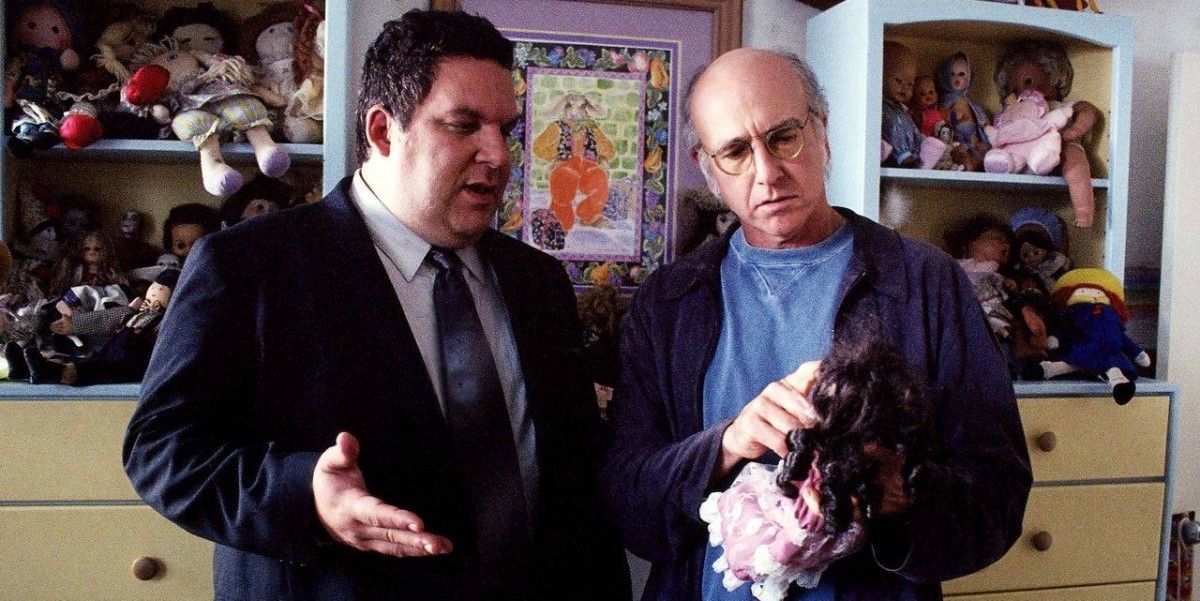 Jeff and Larry look at a doll on 'Curb Your Enthusiasm'
