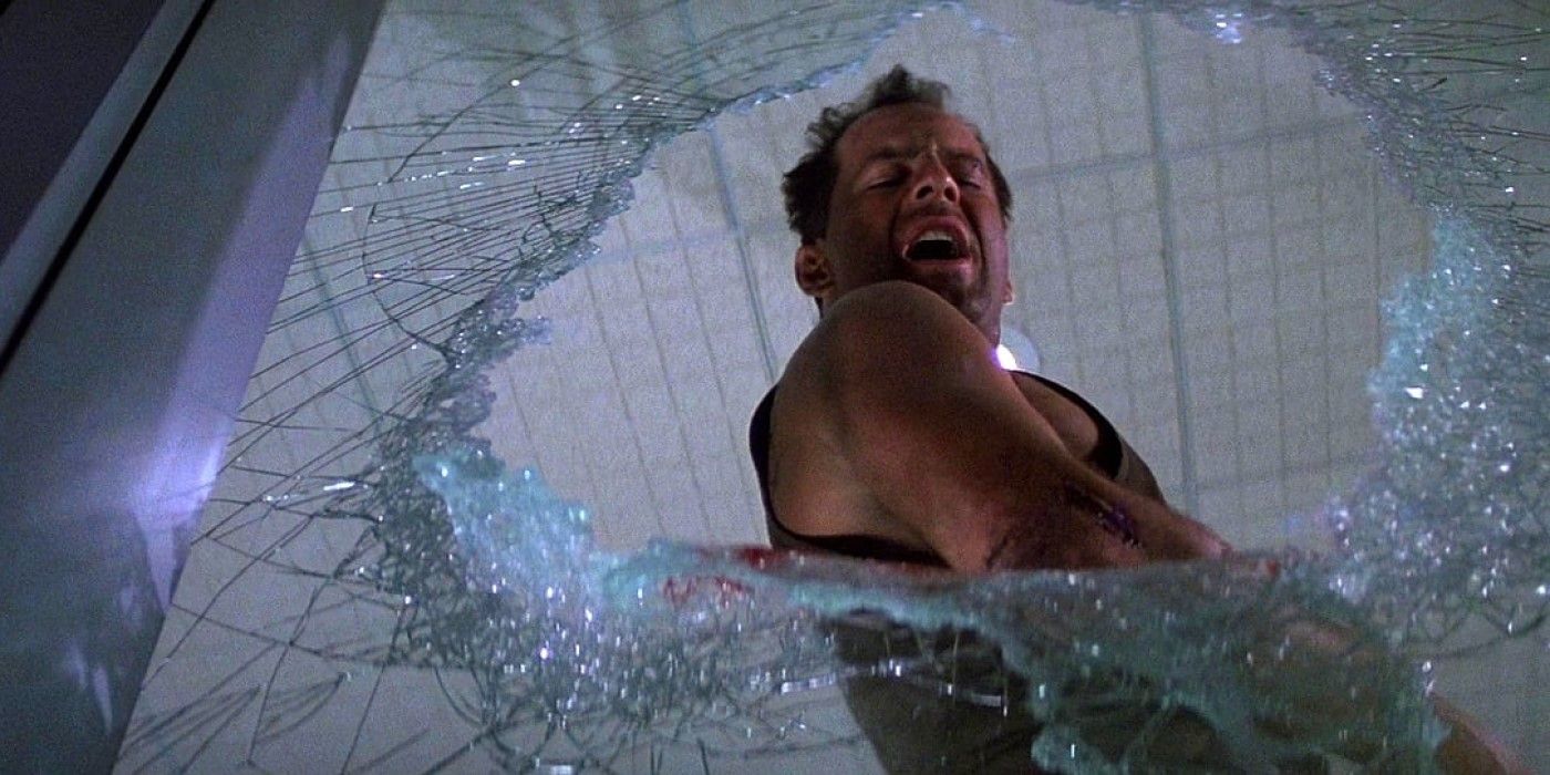 Bruce Willis as John McClane looking down from a broken window in Die Hard.