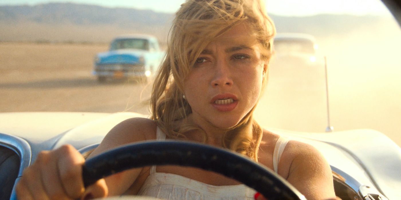 Alice (Florence Pugh) driving away with a distressed look on her face in Don't Worry Darling