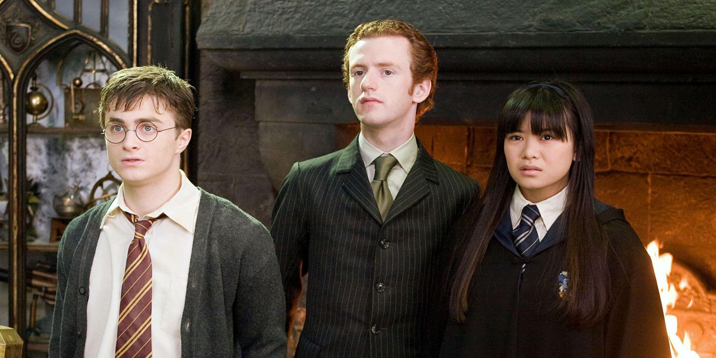 Percy Weasley (Chris Rankin) holding Harry Potter (Daniel Radcliffe) and Cho Chang (Katie Leung) by the back of their sweaters in Harry Potter and the Order of the Phoenix