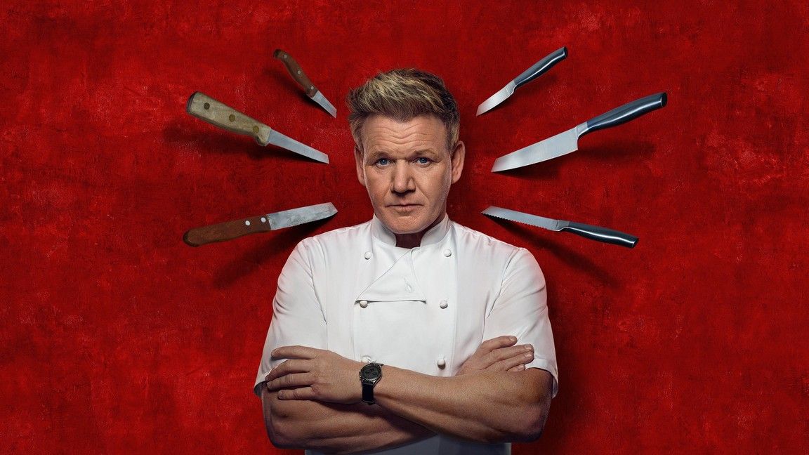 Hell's Kitchen promo photo of Gordon Ramsay with knives stuck in a wall behind him